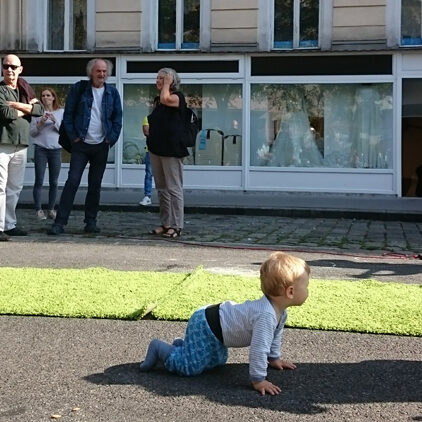 Hannovermarkt-Straßenfest, ein Baby krabbelt im Vordergrund